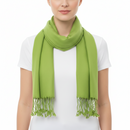 A bright lime green scarf with fringed ends, wrapped around the neck of a model wearing a white t-shirt against a plain white background.