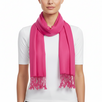 A bright pink scarf with fringed ends, worn in a loop around the neck of a model wearing a white t-shirt, against a plain white background.