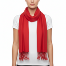 A bright red scarf with fringed ends, worn around the neck of a model wearing a white t-shirt against a plain white background.