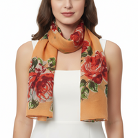 A peach-colored scarf with a large red rose print, draped elegantly.