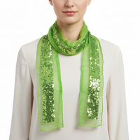 A green sequin belt with a scarf attachment, draped and spread out.