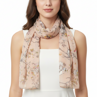 A scarf with a pattern that includes trees and flowers, primarily in a beige color.