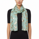 A green scarf with large gold foil butterfly patterns.