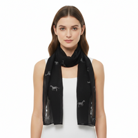 A black scarf with silver glitter horse patterns spread out across it, displayed on a white background.
