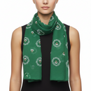 A green scarf with a printed pattern featuring what appears to be reindeer and foliage.