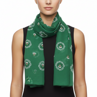 A green scarf with a printed pattern featuring what appears to be reindeer and foliage.