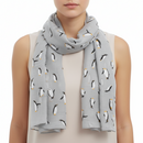 A gray scarf with mini penguin patterns spread out on it, displayed in a loose, casual style against a white background.