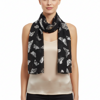 A black scarf with a pattern of silver foil butterflies.