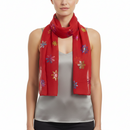 A red scarf with multicolored foil snowflake patterns.