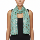 A green scarf with a pattern of mini gold foil butterflies.