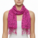 A pink scarf with black peace sign print and tassels