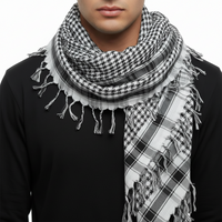 A black and white checkered square scarf with tassels on the edges.