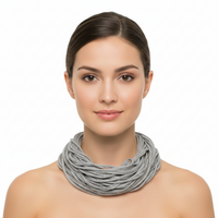 Woman wearing a gray scarf on a white background