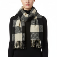 A multicolored checkered scarf with tassels displayed on a white background.