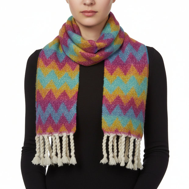 A multicolored geometric patterned winter scarf with rope tassels.