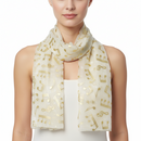 White scarf with gold musical note pattern on a white background