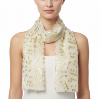 White scarf with gold musical note pattern on a white background