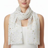 Woman wearing a white scarf with gold star patterns on a white background