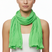 A green soft wrinkled scarf draped and displayed on a plain background