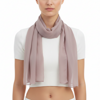 A mauve chiffon scarf draped and laid out on a plain surface.