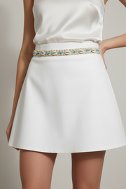A beige belt with blue beads and seashells, featuring adjustable strings.