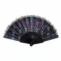 A black lace fan with a Day of the Dead skull and floral pattern.