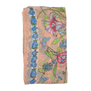 Floral patterned fabric with blue flowers and green leaves on a peach background