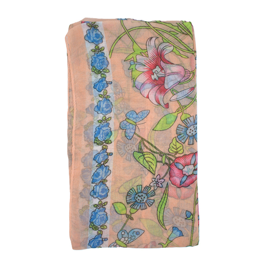 Floral patterned fabric with blue flowers and green leaves on a peach background