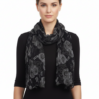Woman wearing a black patterned scarf on a white background