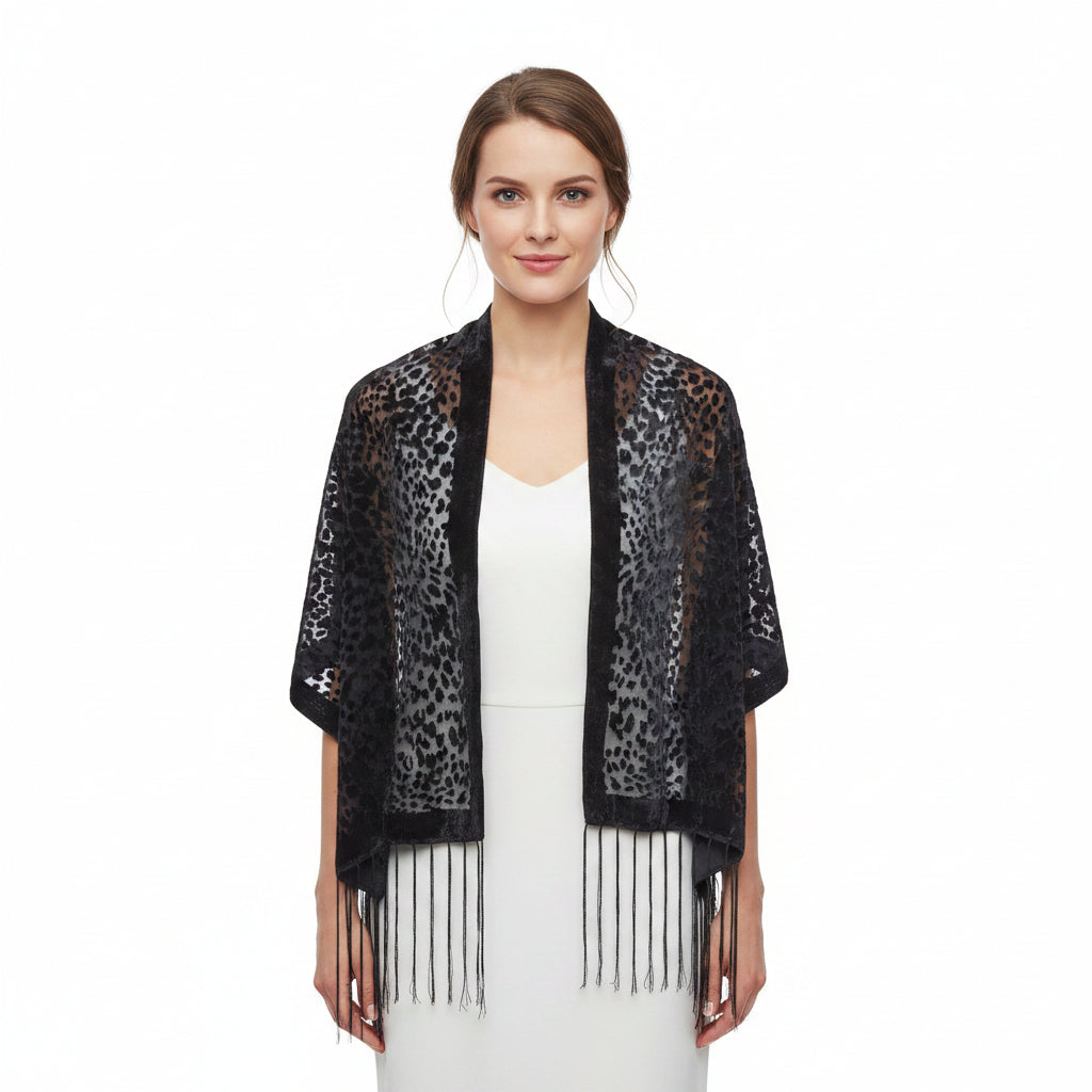 Two black and gray leopard print shawls with fringe, displayed on white mannequins against a white background.