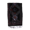 A black embroidered prayer shawl with intricate geometric and circular patterns in red, purple, and silver, featuring fringe at the bottom, shown against a plain white background.