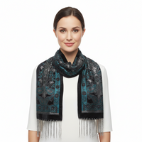 A black velvet prayer shawl with intricate teal, silver, and black embroidery, featuring a central floral and geometric pattern and a long fringe at the bottom, shown against a plain white background.