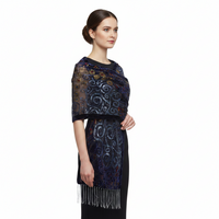 A dark blue patterned scarf with intricate swirls, geometric shapes, and gold circular accents, finished with fringed edges, shown against a plain white background.