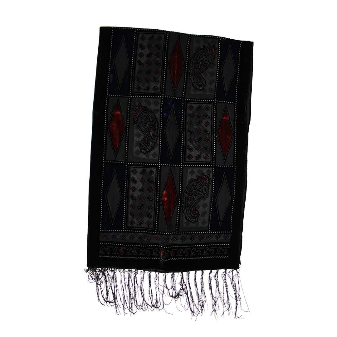 A black woven scarf with geometric and paisley patterns, featuring red accents and fringed edges, shown against a plain white background.