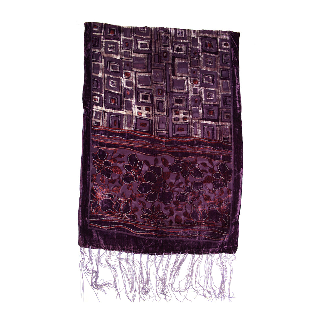 A dark purple patterned scarf with fringed ends, featuring geometric and floral motifs on a white background.