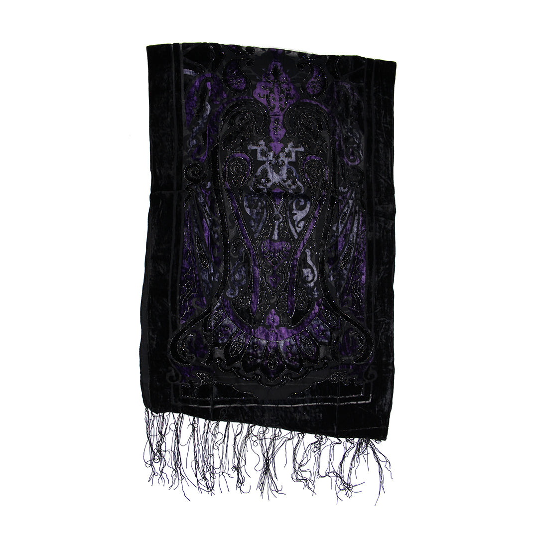 A black velvet prayer shawl with intricate purple and black embroidered angel motifs and matching fringed edges, shown against a plain white background.