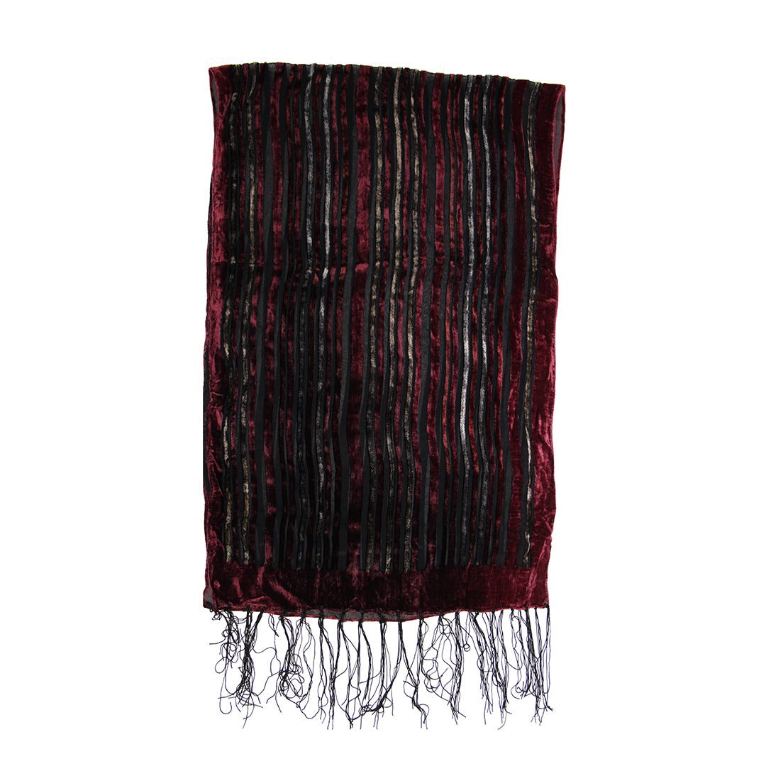 A rectangular burgundy velvet scarf with vertical black and metallic silver stripes and fringed tassels at the bottom, shown against a plain white background.