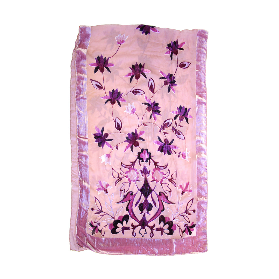 A pink embroidered scarf or shawl featuring a floral vine pattern in shades of purple, magenta, and black, finished with a matching pink border.