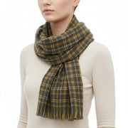 A checkered scarf in black, gray, and yellow colors, draped and displayed on a plain background.